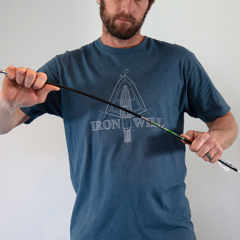 flexing an arrow with hands