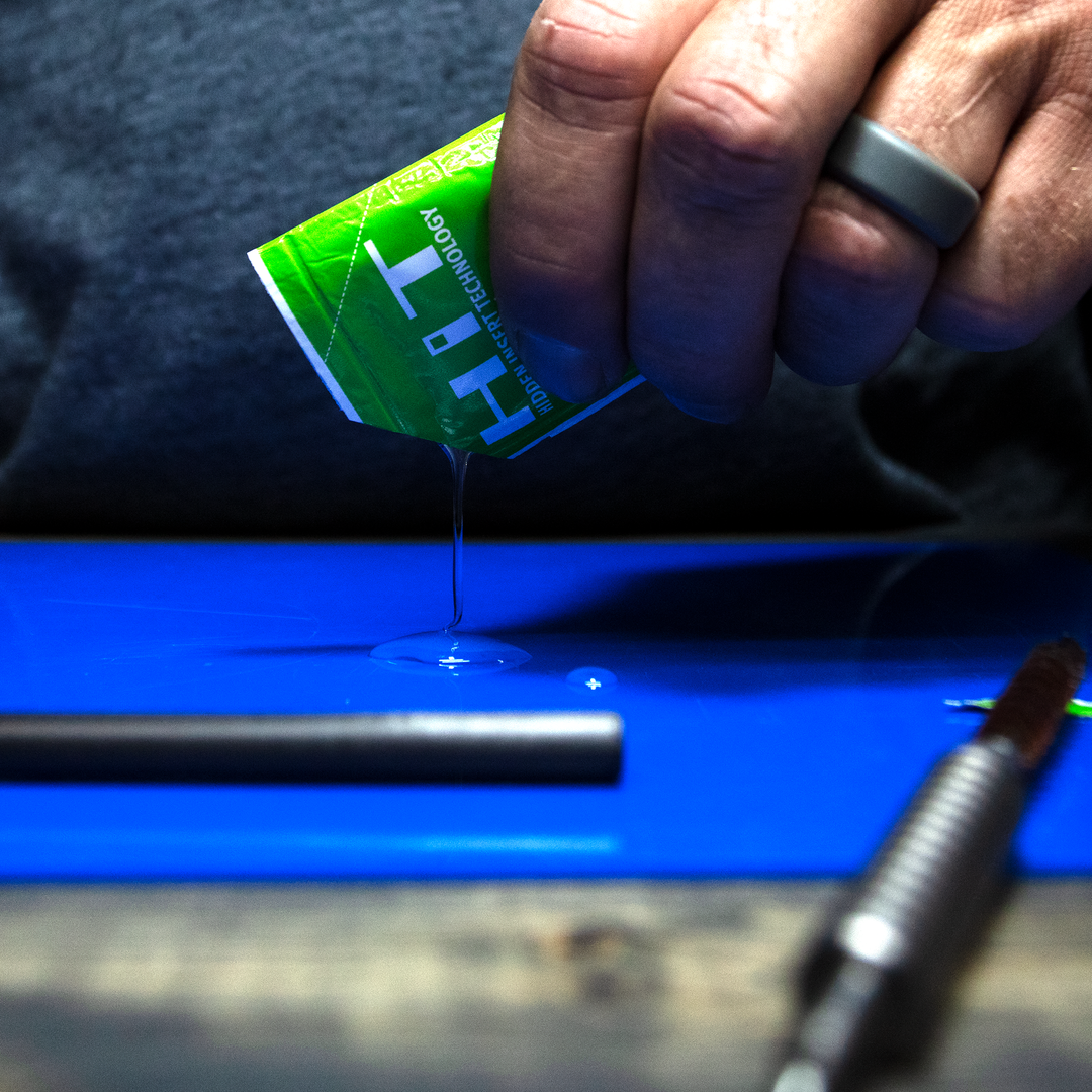 pouring epoxy onto a table with an arrow in foreground.
