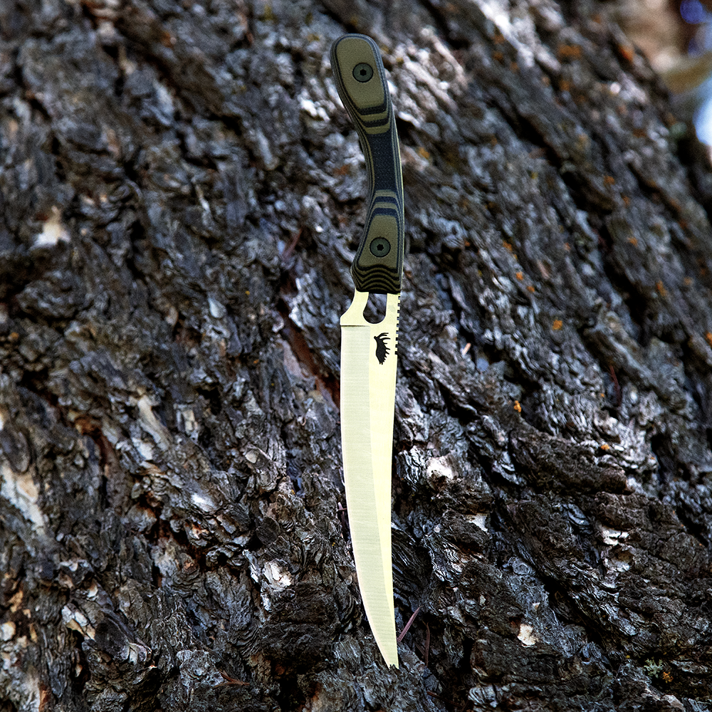 sharp boning filet knife over bark