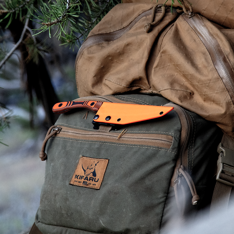 K3 ultralight boning knife in a sheath on top of a backpack