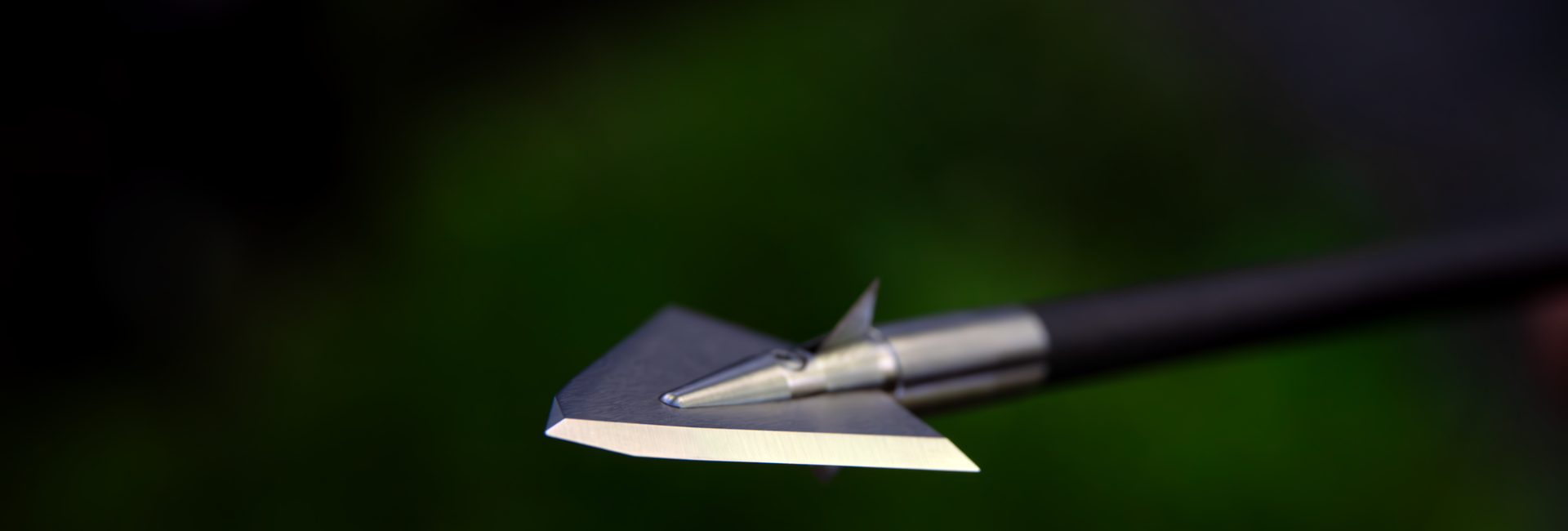 picture of an arrow with a broadhead on it with a faded out green and black background