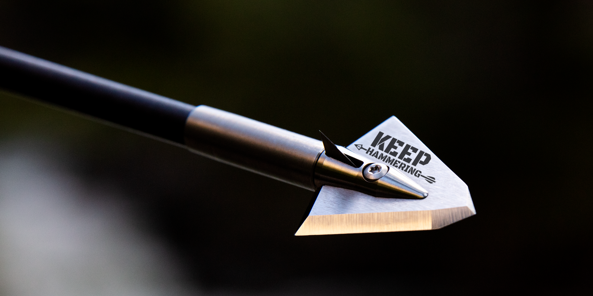 arrow with keep hammering text over black background
