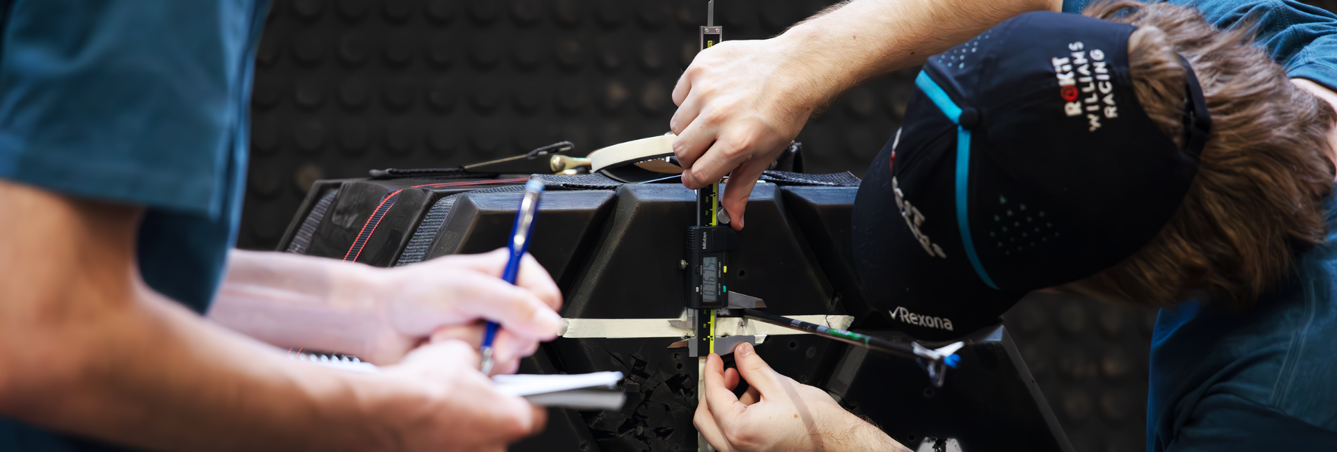 university scientists measuring taking measurements on a target with an arrow in it