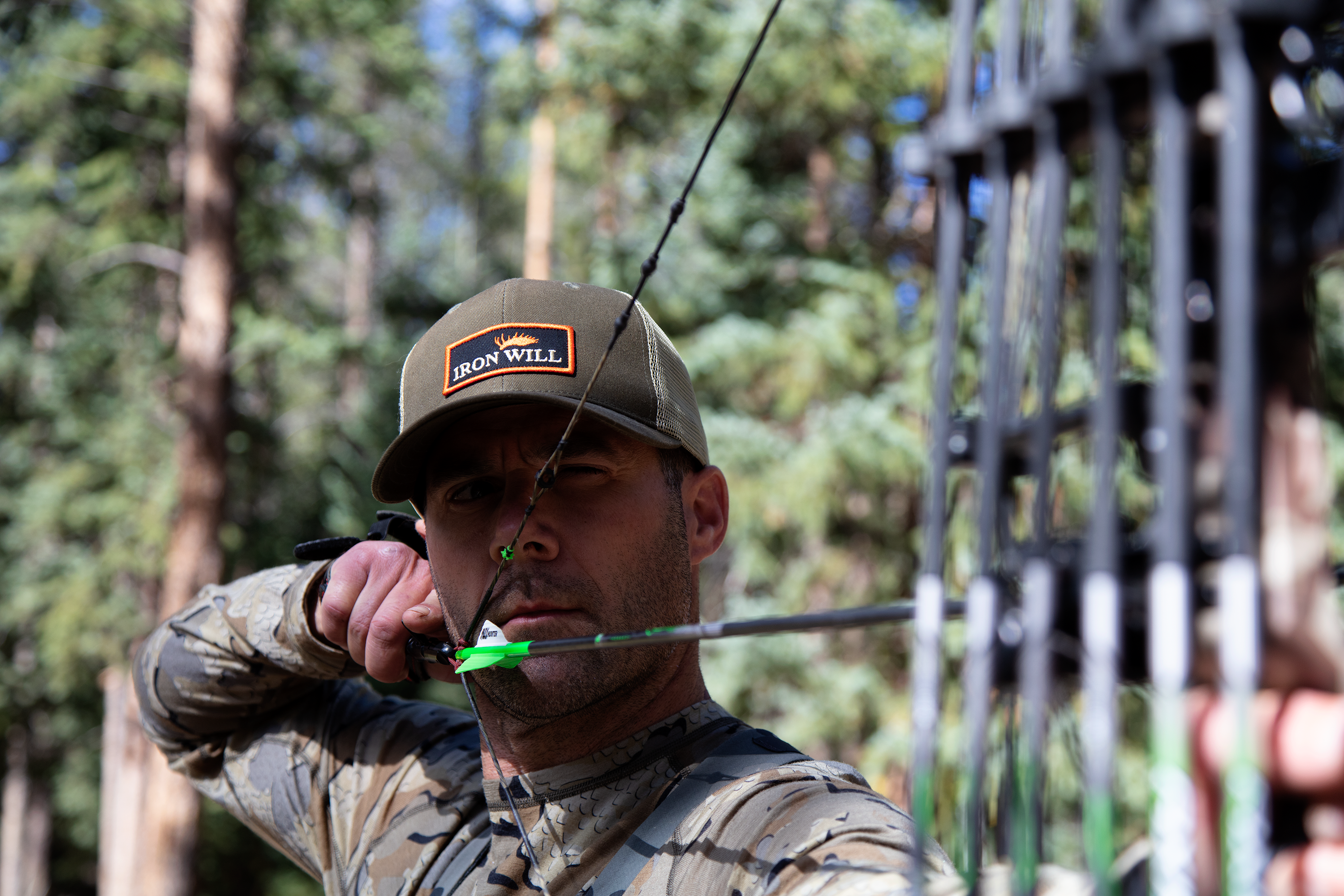 A bow hunter steadies his bow for an accurate shot