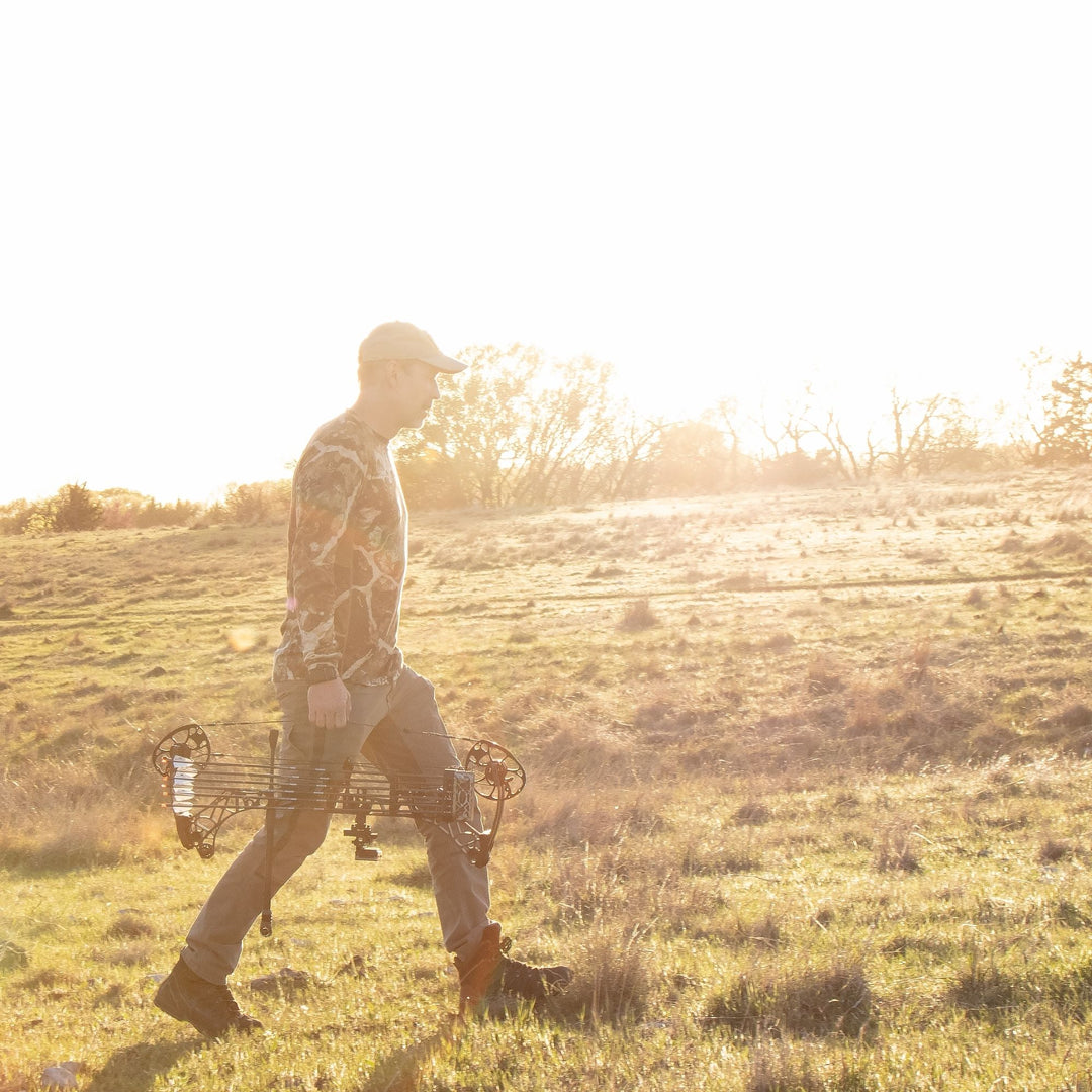 picture of Bill Vanderheyden walking through a cattle pasture in Texas while looking for wild hogs to test broadheads on.