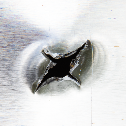 hole from a single bevel broadhead in metal