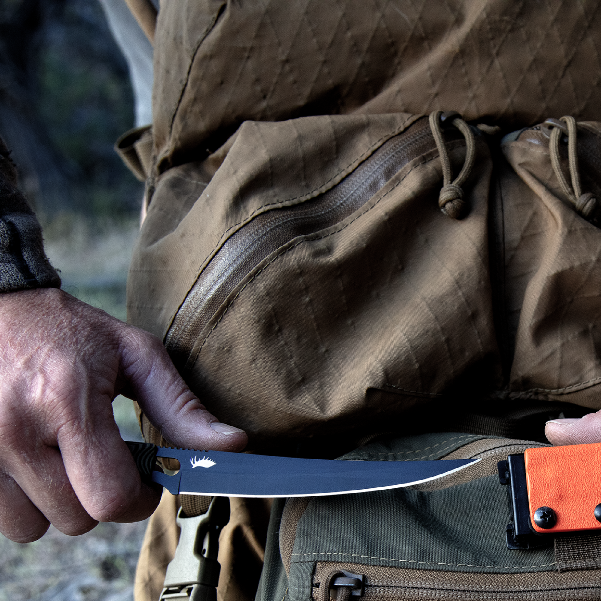 K3 Ultralight Boning Knife for Bow Hunters being unsheathed over a backpack, but a square photo version