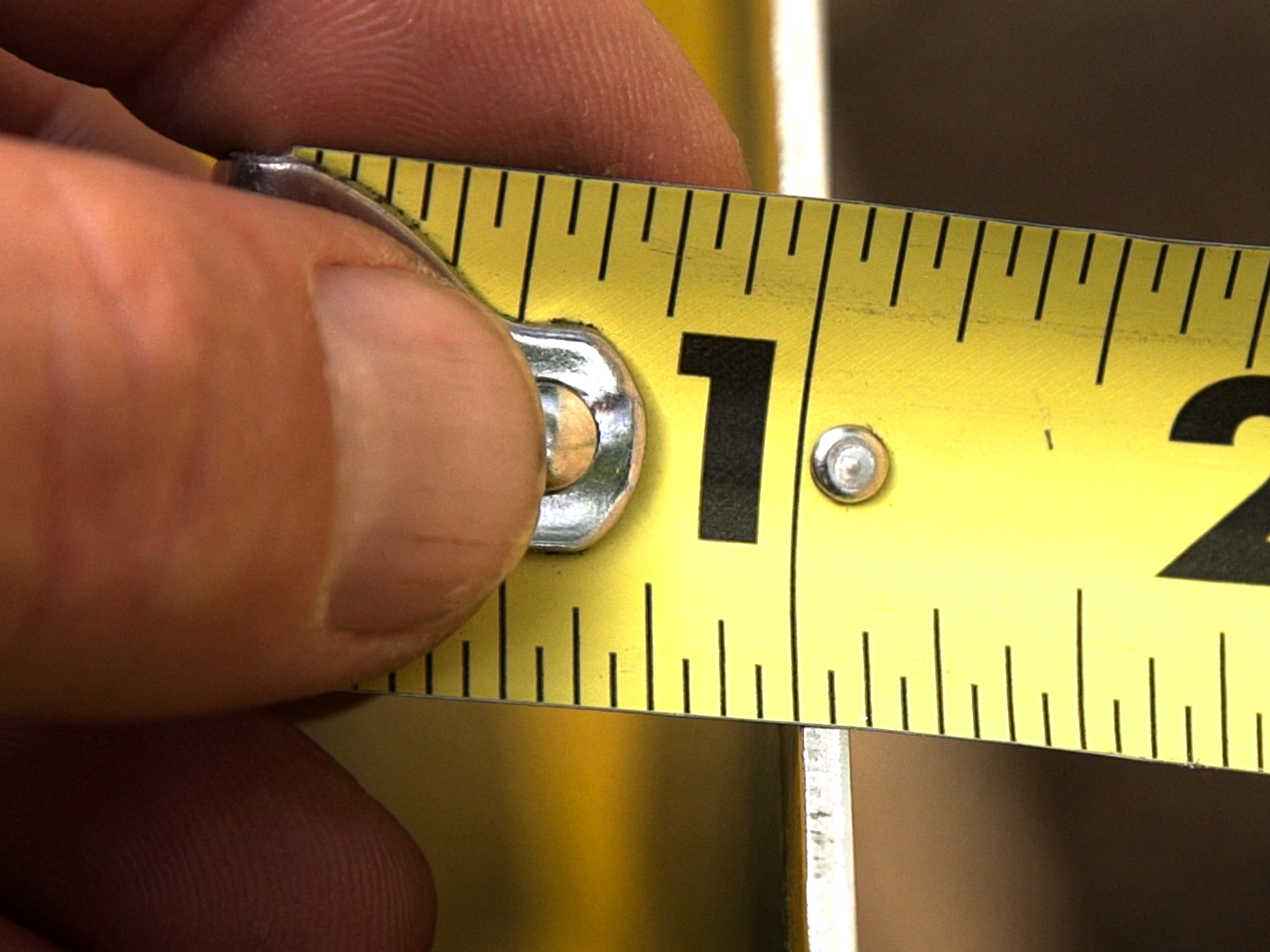 ruler showing the thickness of a metal sign, which appears to be approximately 1 little line and a half from the biggest line